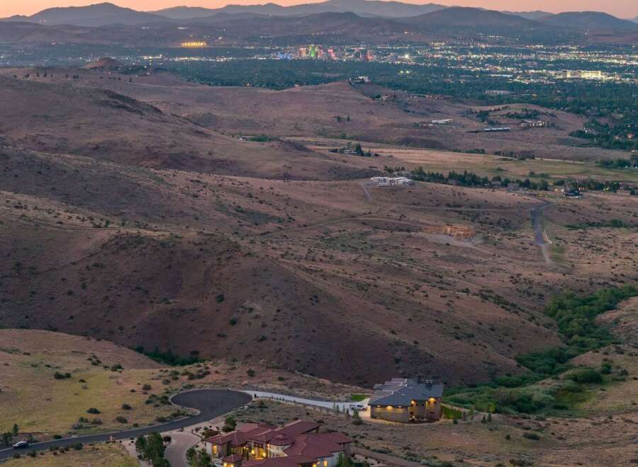 Experience luxury living with this stunning estate offering panoramic views of the city lights and surrounding mountains.