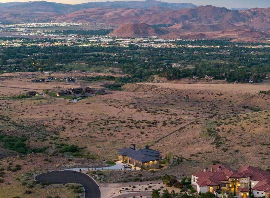 Experience luxury living in this stunning estate, nestled amidst rolling hills with panoramic views of the city lights and majestic mountains.