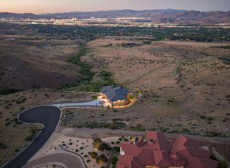 Experience luxury living with this stunning estate nestled in the hills, offering panoramic views of the city lights.