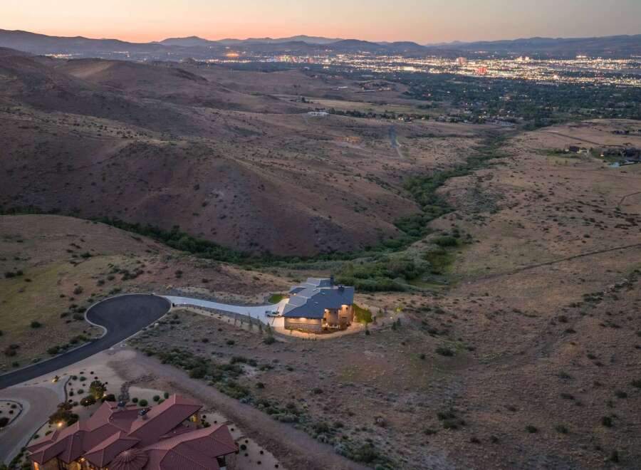 Experience luxury living with this stunning modern home nestled in the hills, offering breathtaking panoramic views of the city lights.