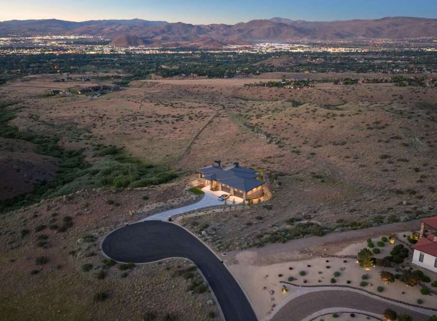 Experience luxury living in this stunning modern home, nestled in a serene landscape with breathtaking panoramic views of the city lights and mountains.
