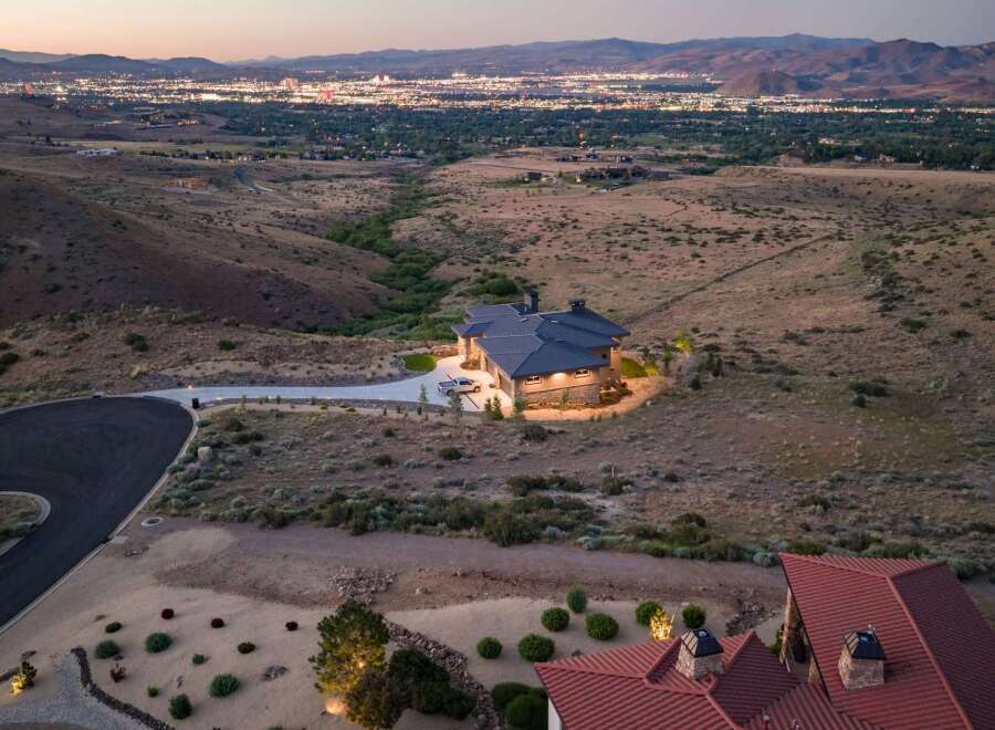 Experience luxury living in this stunning custom-built home, perched on a hillside with breathtaking panoramic views of the city lights and surrounding mountains.
