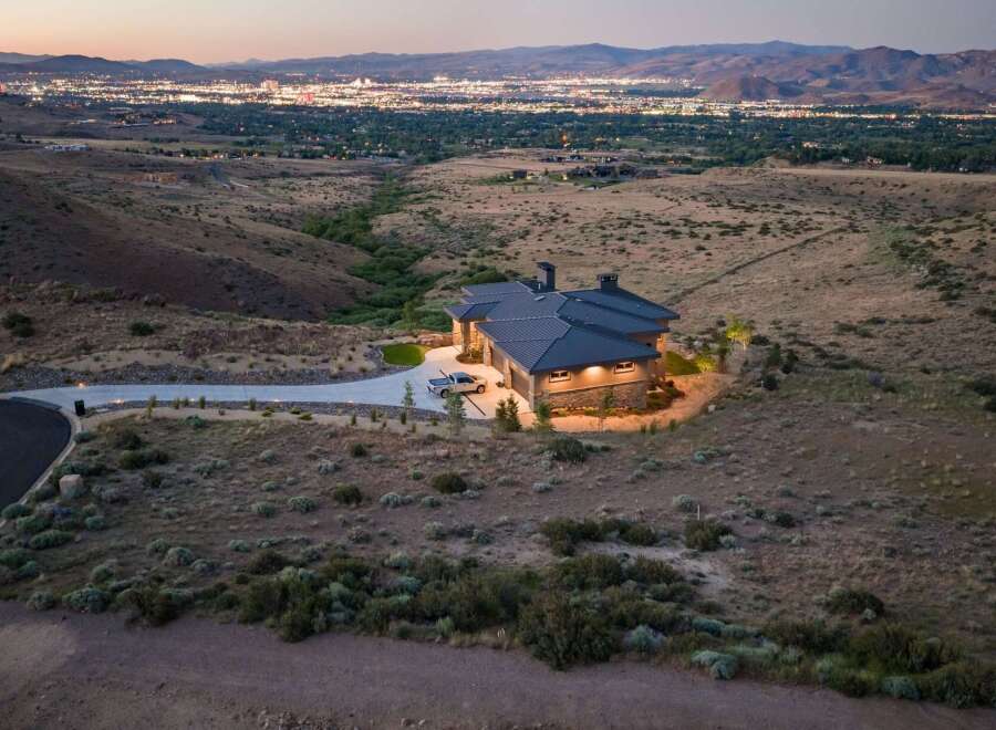 Experience luxury living in this stunning modern home, perched on a hillside with breathtaking panoramic views of the city lights.