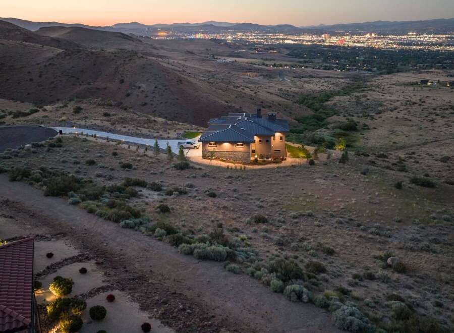 Experience luxury living with this stunning modern home nestled in the hills, offering breathtaking panoramic views of the city lights.