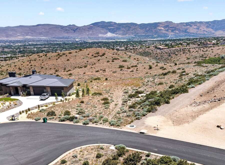 Experience luxury living in this stunning modern home, perched on a hillside with breathtaking panoramic views of the city and mountains.