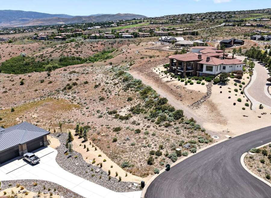 Discover luxury living in this stunning estate, featuring a modern home with a tile roof and expansive windows.
