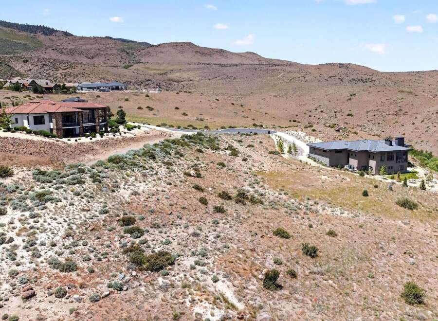 Discover luxury living in this stunning modern home nestled in a serene, hilly landscape.