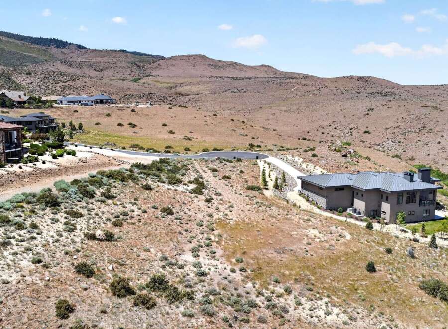 Discover this stunning modern home nestled in a picturesque hillside setting.