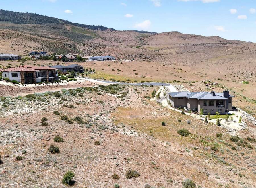 Experience luxury living in this stunning modern home nestled in a picturesque hillside community.