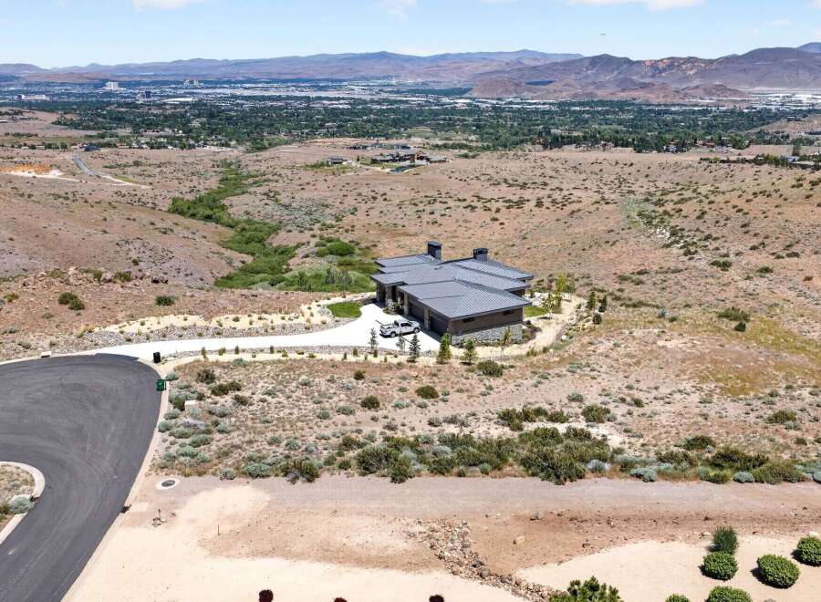 Discover this stunning modern home nestled in a serene, elevated landscape offering panoramic views of the city and mountains.