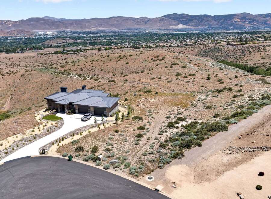 Experience luxury living in this stunning modern home, nestled on a sprawling hillside with breathtaking panoramic views of the valley and mountains.