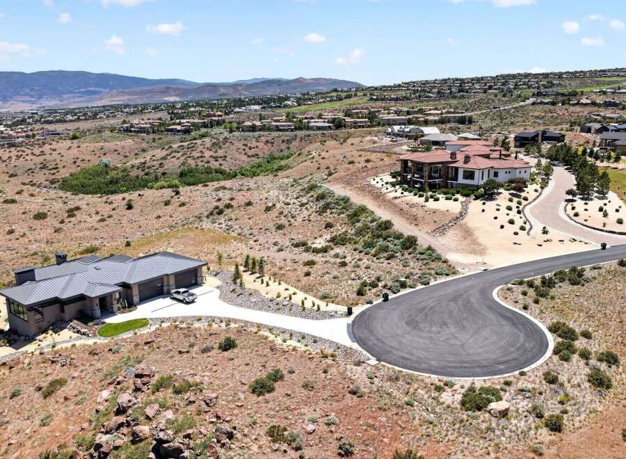 Discover luxury living in this stunning modern home, boasting a sleek metal roof and expansive windows that capture breathtaking panoramic views.