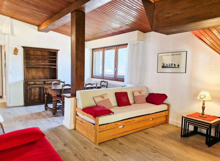 This charming living area features a cozy daybed adorned with decorative pillows, perfect for relaxation.
