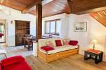 This charming living area features a cozy daybed adorned with decorative pillows, perfect for relaxation.