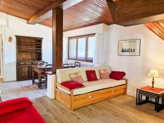 This charming living area features a cozy daybed adorned with decorative pillows, perfect for relaxation.
