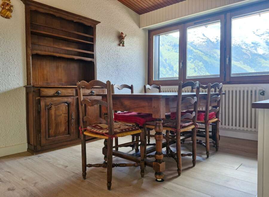Experience cozy dining with this charming wooden table and chairs set, perfect for intimate gatherings.