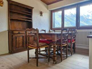 Experience cozy dining with this charming wooden table and chairs set, perfect for intimate gatherings.