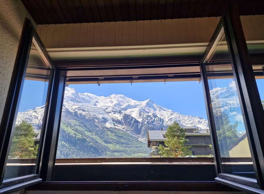 Experience breathtaking mountain views from this stunning property, perfectly framed by expansive windows.