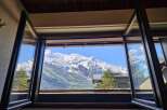 Experience breathtaking mountain views from this stunning property, perfectly framed by expansive windows.
