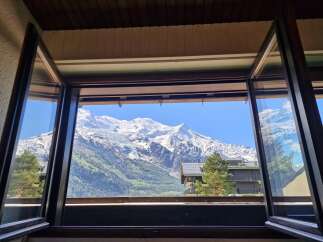 Experience breathtaking mountain views from this stunning property, perfectly framed by expansive windows.