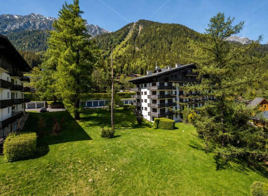 Experience luxury mountain living in this stunning property, featuring modern architecture with ample balconies offering breathtaking views of the surrounding Alps.