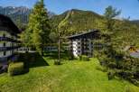 Experience luxury mountain living in this stunning property, featuring modern architecture with ample balconies offering breathtaking views of the surrounding Alps.