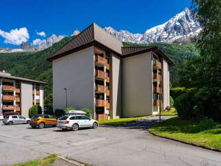 Experience mountain living in this stunning apartment complex, offering breathtaking views of snow-capped peaks and lush green valleys.
