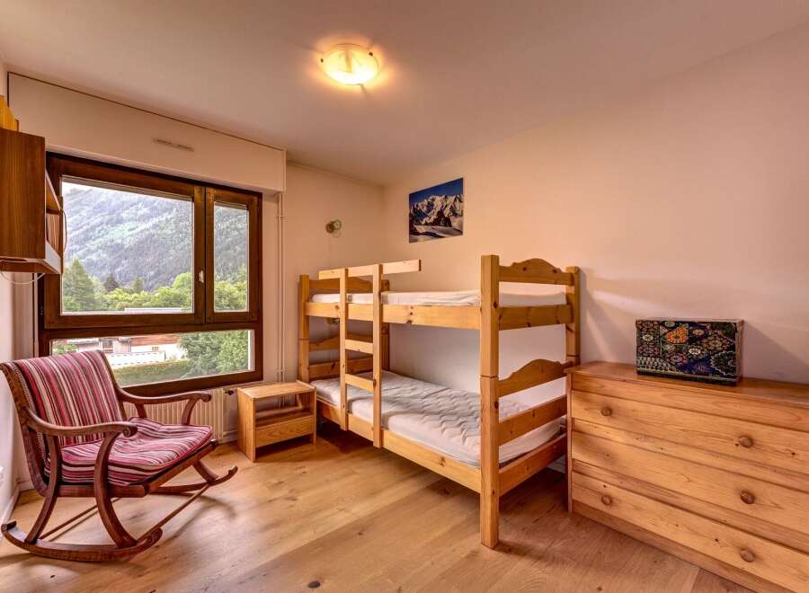 This charming bedroom features a cozy bunk bed, perfect for families or groups.