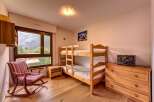 This charming bedroom features a cozy bunk bed, perfect for families or groups.