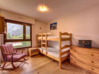 This charming bedroom features a cozy bunk bed, perfect for families or groups.