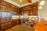 Experience luxury in this stunning kitchen featuring custom wood cabinetry and granite countertops.