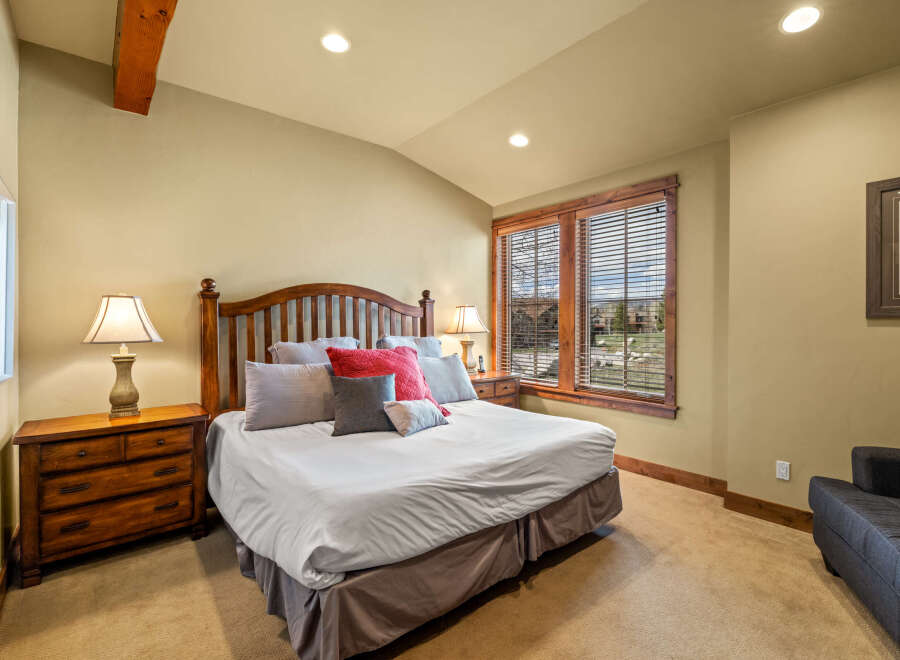 Experience rustic charm in this inviting bedroom, featuring a sturdy wooden bed frame and coordinating nightstands.