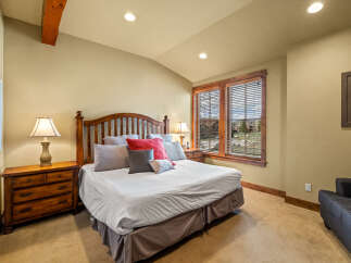 Experience rustic charm in this inviting bedroom, featuring a sturdy wooden bed frame and coordinating nightstands.