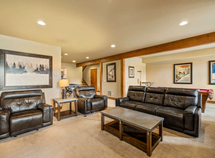 This spacious basement living area offers a comfortable and inviting atmosphere, perfect for relaxation and entertainment.
