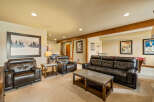 This spacious basement living area offers a comfortable and inviting atmosphere, perfect for relaxation and entertainment.