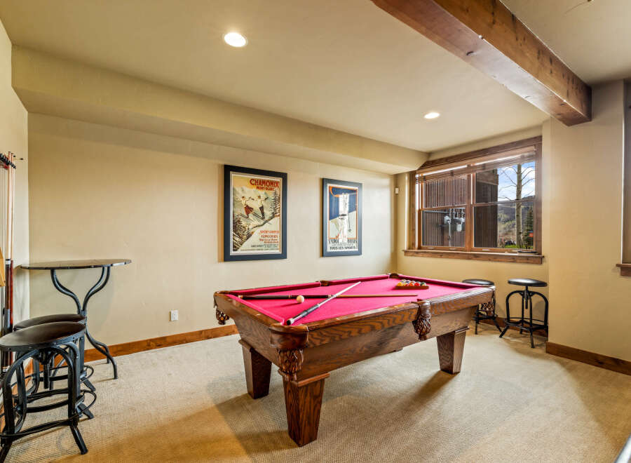 Enjoy endless entertainment in this dedicated game room, featuring a classic billiard table perfect for friendly competitions.