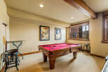 Enjoy endless entertainment in this dedicated game room, featuring a classic billiard table perfect for friendly competitions.
