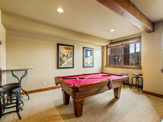 Enjoy endless entertainment in this dedicated game room, featuring a classic billiard table perfect for friendly competitions.