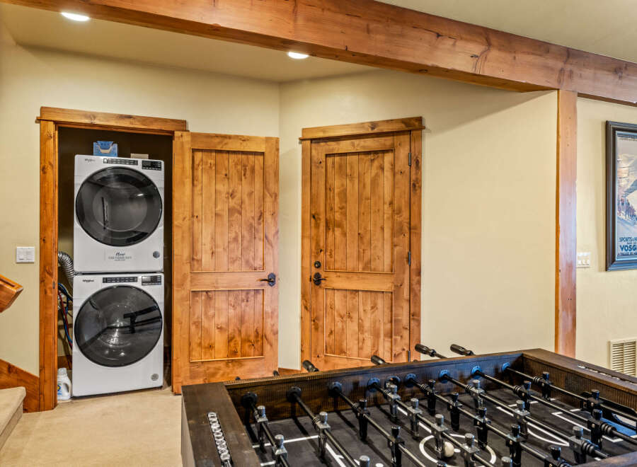 Discover this charming space featuring a stacked Whirlpool washer and dryer, perfect for laundry needs.