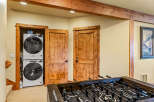 Discover this charming space featuring a stacked Whirlpool washer and dryer, perfect for laundry needs.