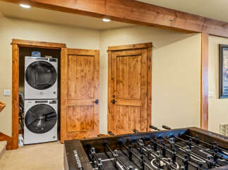 Discover this charming space featuring a stacked Whirlpool washer and dryer, perfect for laundry needs.