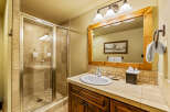 This charming bathroom features a spacious glass-enclosed shower with elegant tilework, perfect for a relaxing experience.