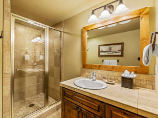 This charming bathroom features a spacious glass-enclosed shower with elegant tilework, perfect for a relaxing experience.