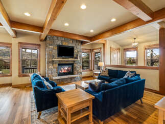 Experience rustic charm in this inviting living room, featuring a magnificent stone fireplace as the centerpiece.