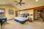 Experience ultimate comfort in this spacious master bedroom, featuring a luxurious king-size bed with plush bedding and decorative pillows.