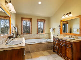Experience luxury in this spacious bathroom featuring a deep soaking tub perfect for relaxation.