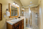 This beautifully appointed bathroom features a spacious walk-in shower with elegant tilework and a glass enclosure.
