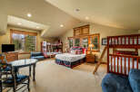 This spacious bedroom offers comfortable sleeping arrangements for multiple guests with two bunk beds and a queen-size bed.