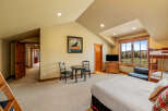 This spacious bedroom offers a comfortable retreat with a large bed and a bunk bed, perfect for families or groups.