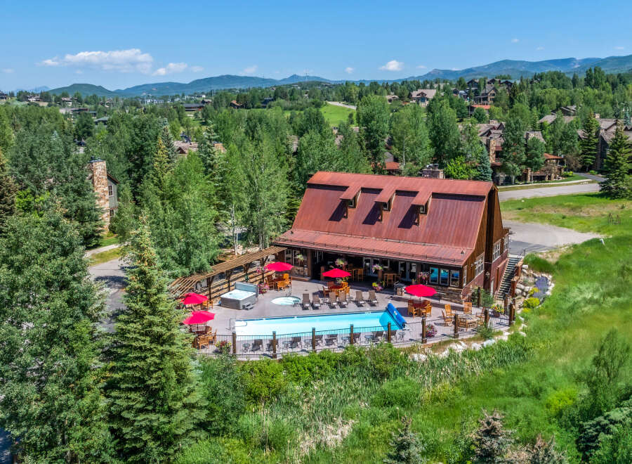 Experience luxury mountain living with this stunning property featuring a sparkling swimming pool and a relaxing hot tub, perfect for unwinding after a day of adventure.